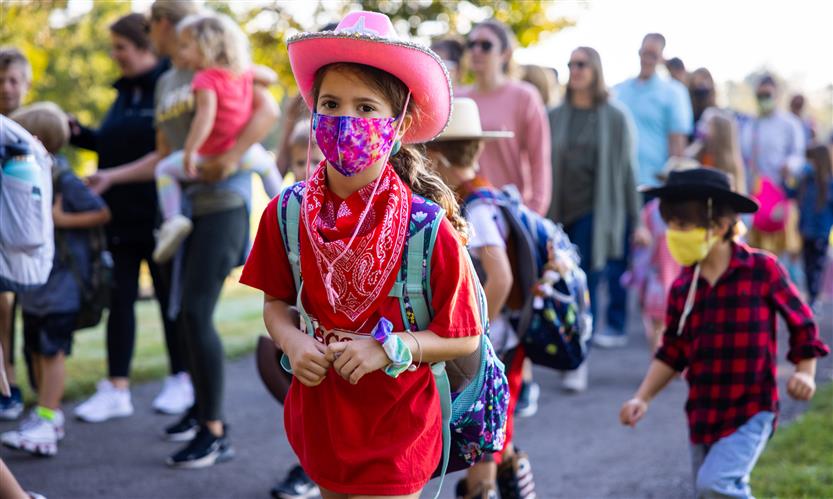 Students wearing western wear walk to school